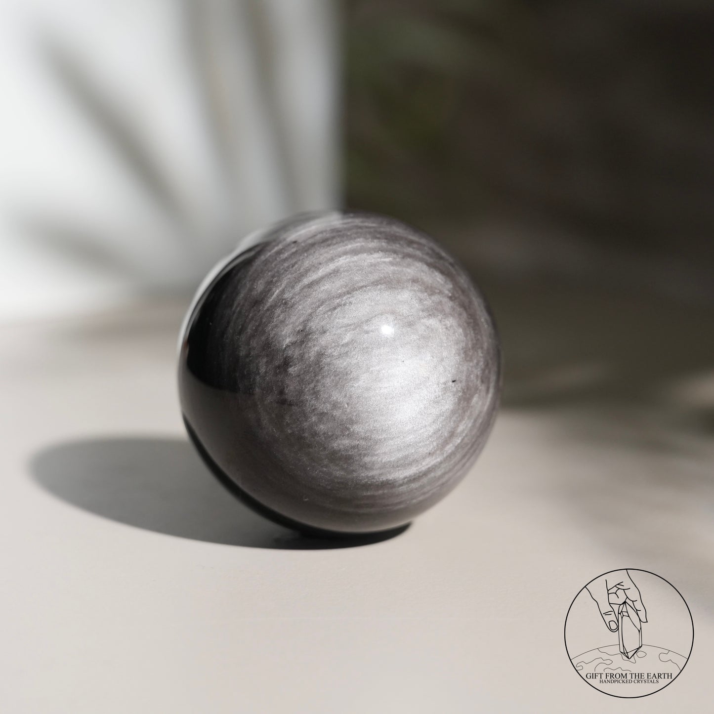 Silver sheen obsidian sphere