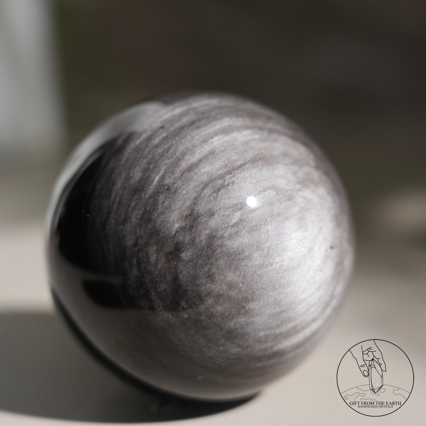 Silver sheen obsidian sphere