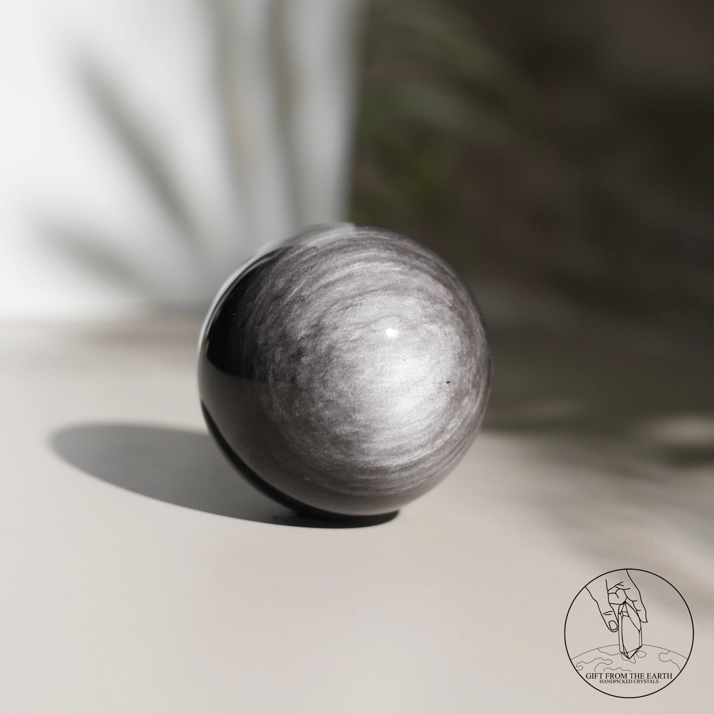 Silver sheen obsidian sphere