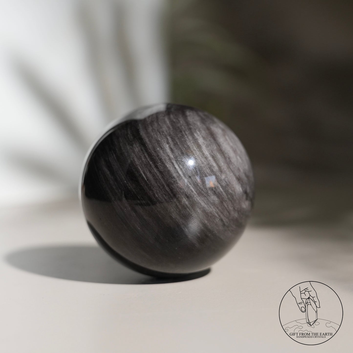 Silver sheen obsidian sphere