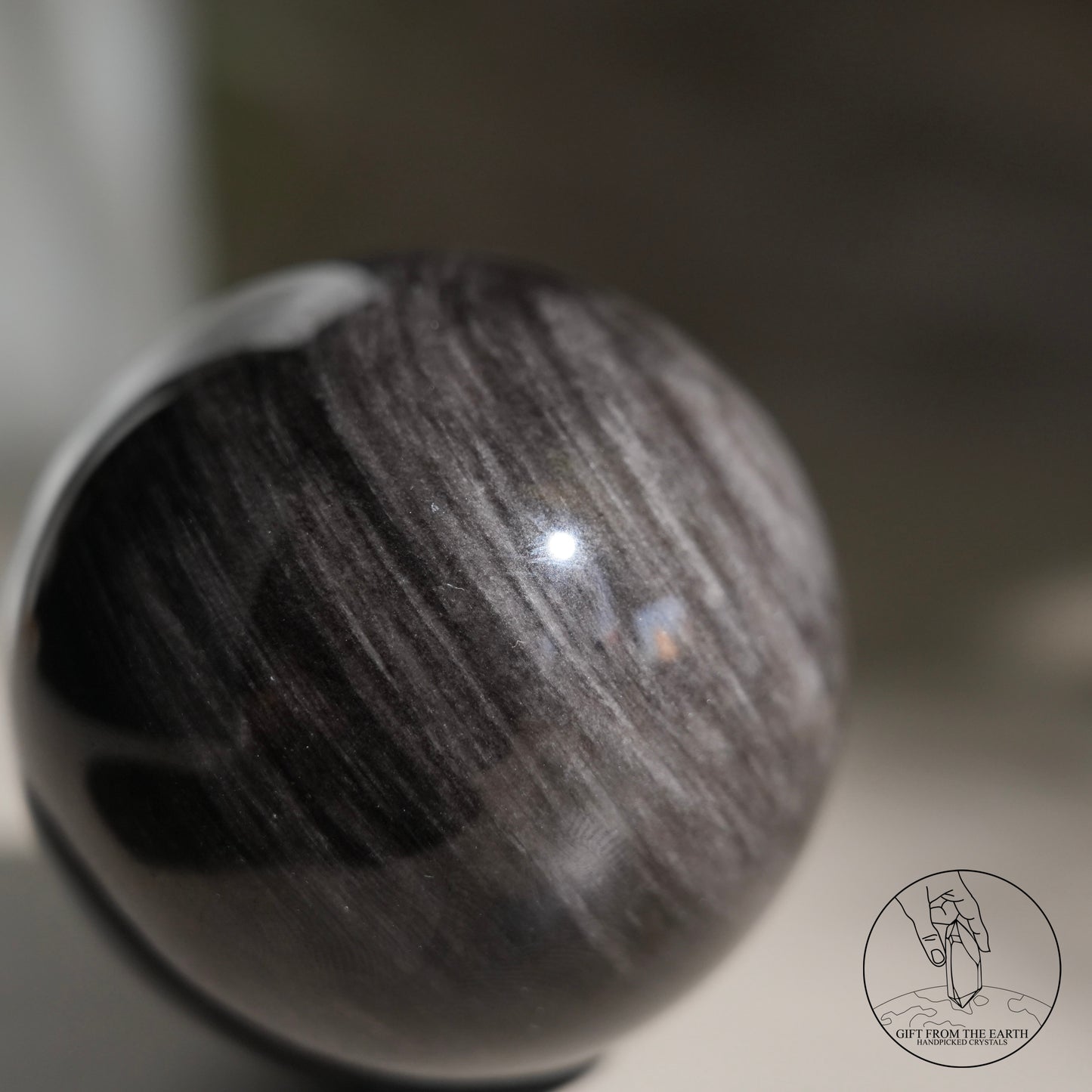 Silver sheen obsidian sphere