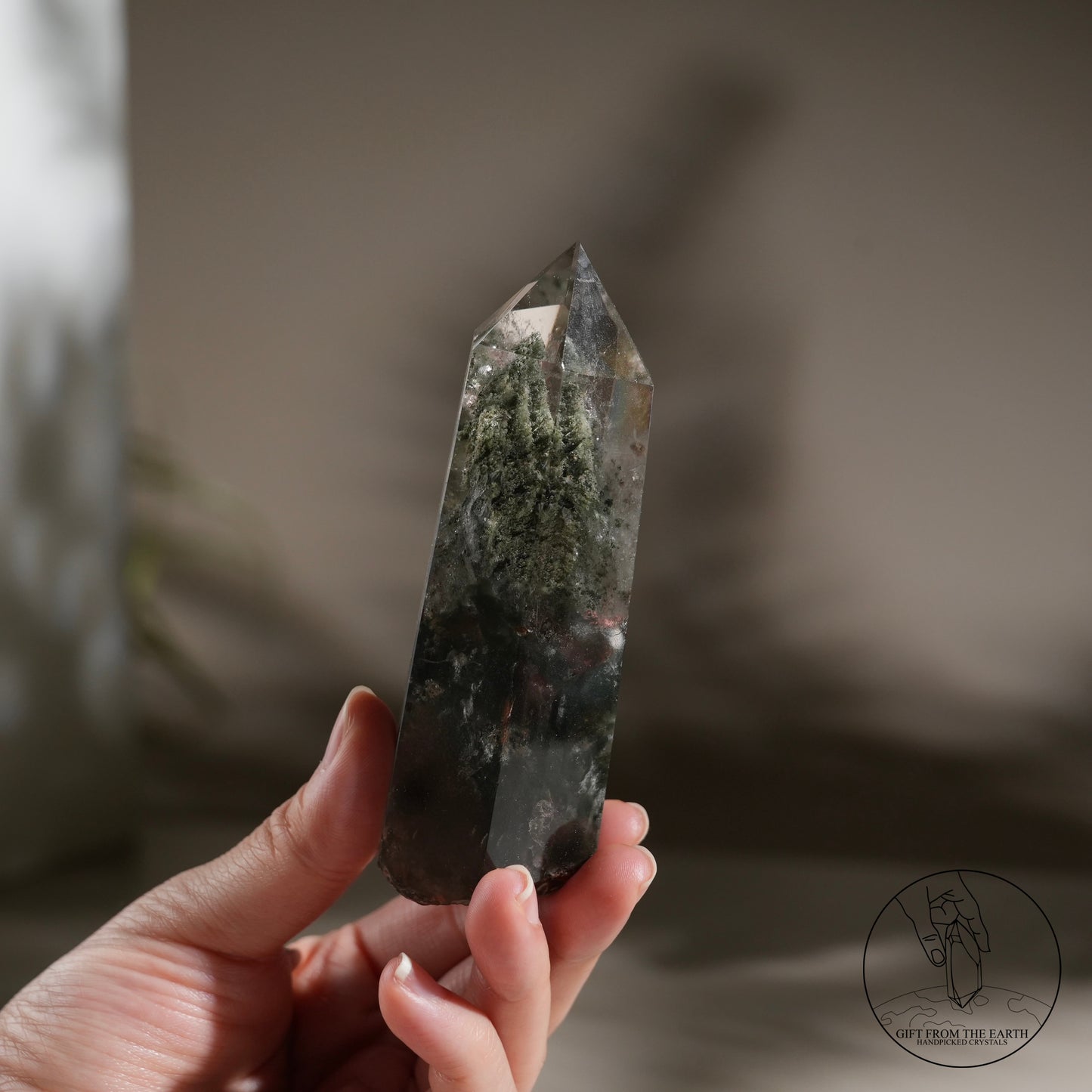 Half-polished multi-layered red-green phantom quartz point