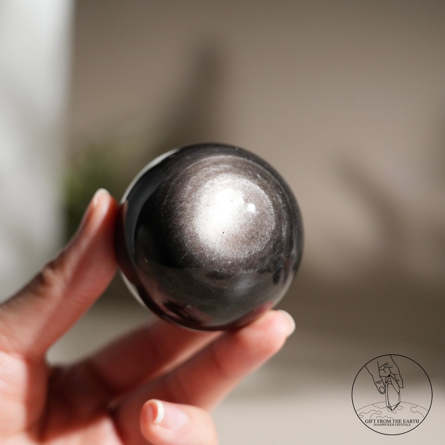 Silver sheen obsidian sphere