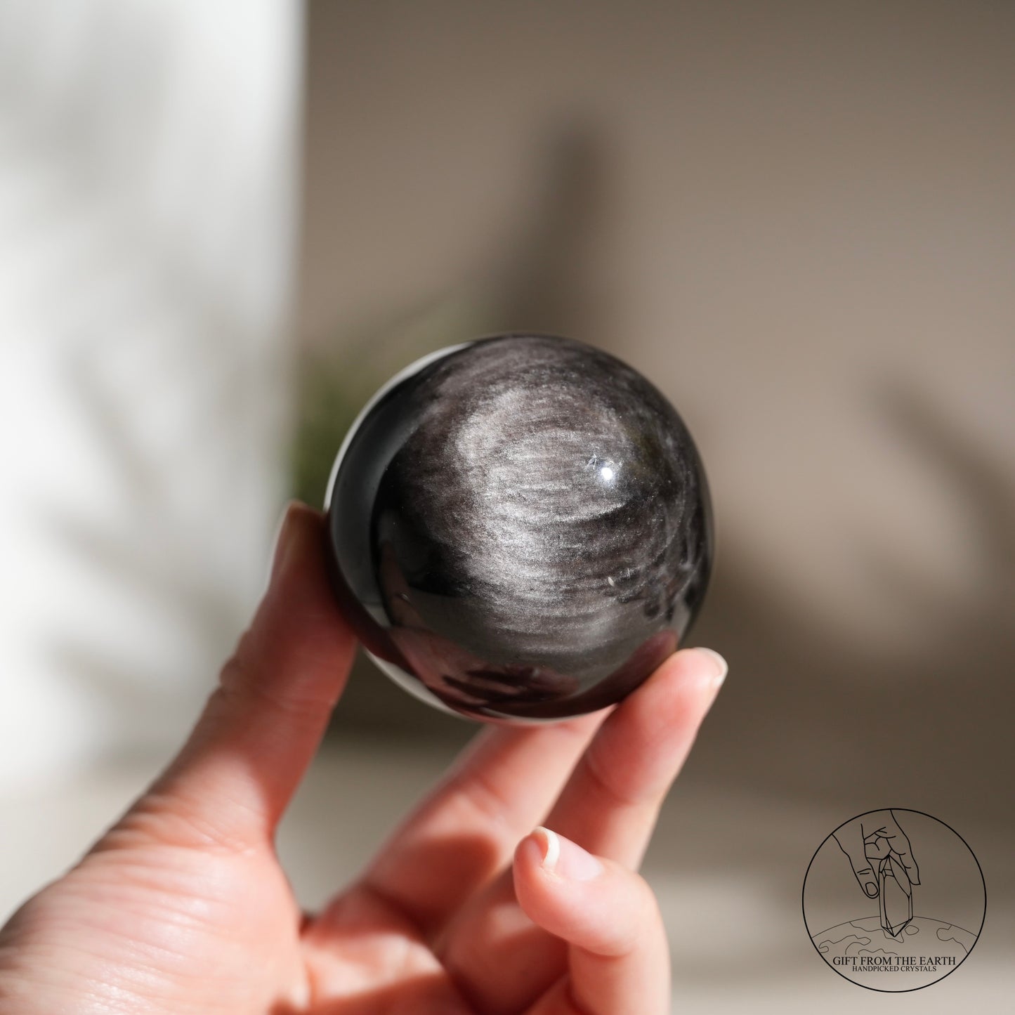 Silver sheen obsidian sphere