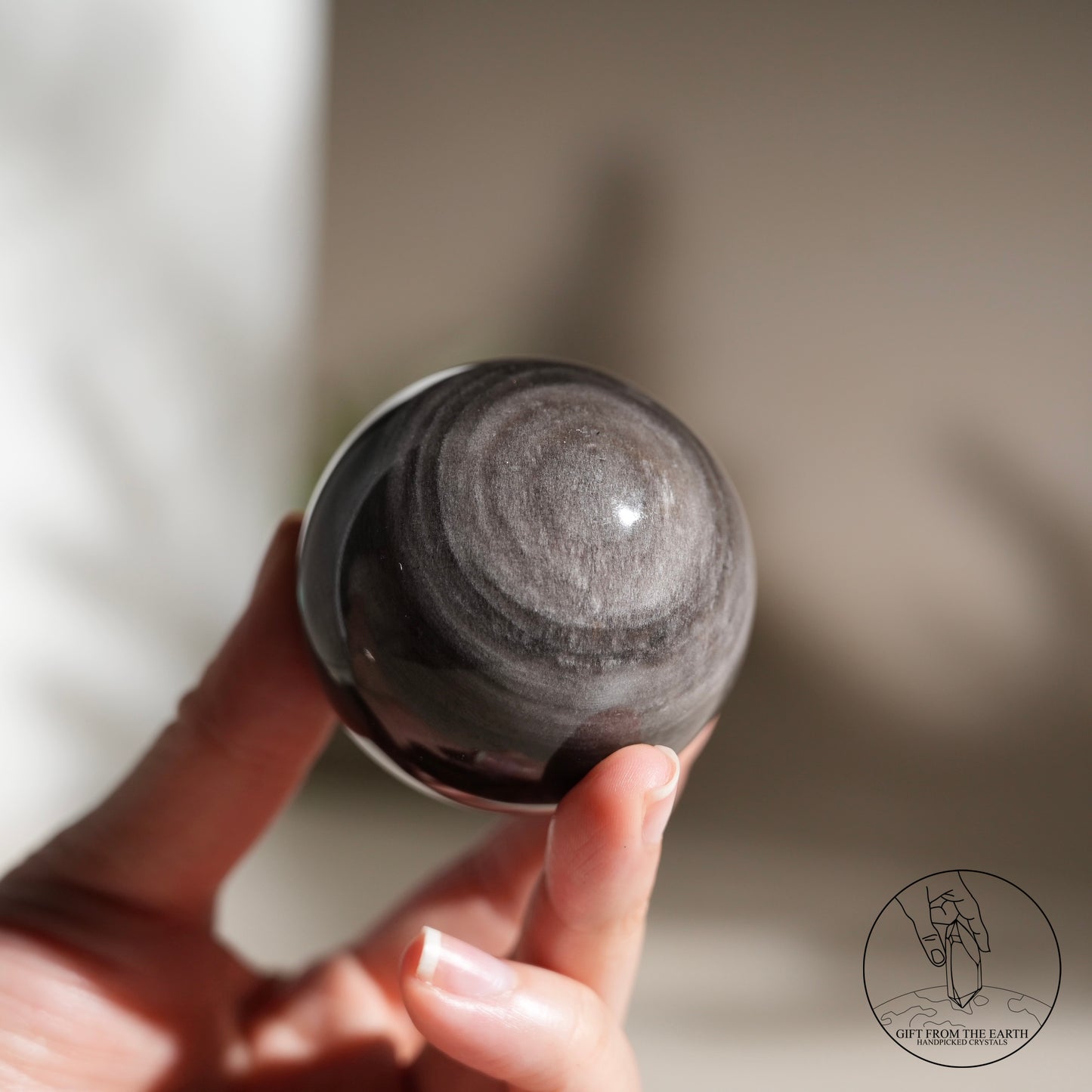 Silver sheen obsidian sphere