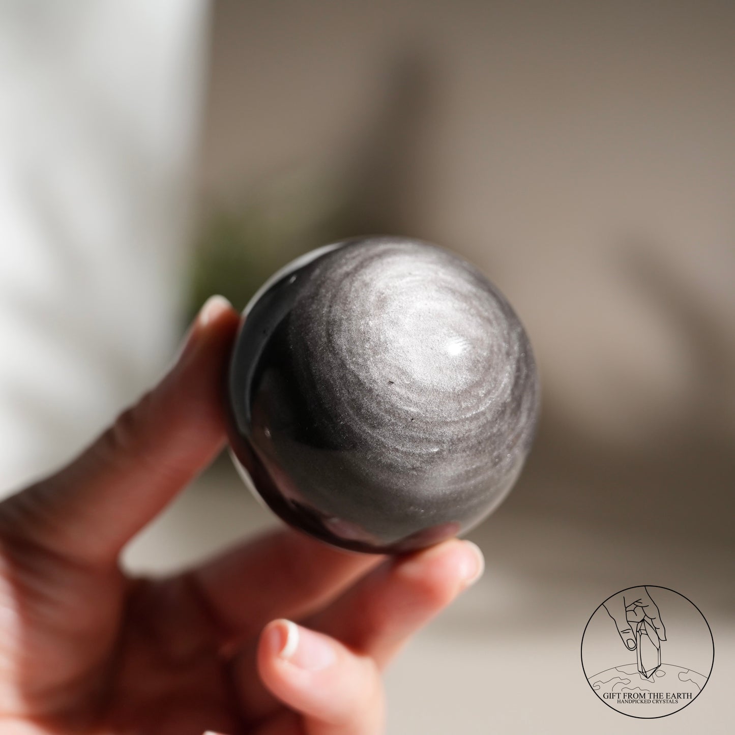 Silver sheen obsidian sphere