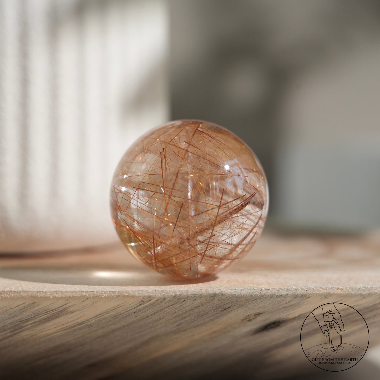 Golden rutilated quartz sphere