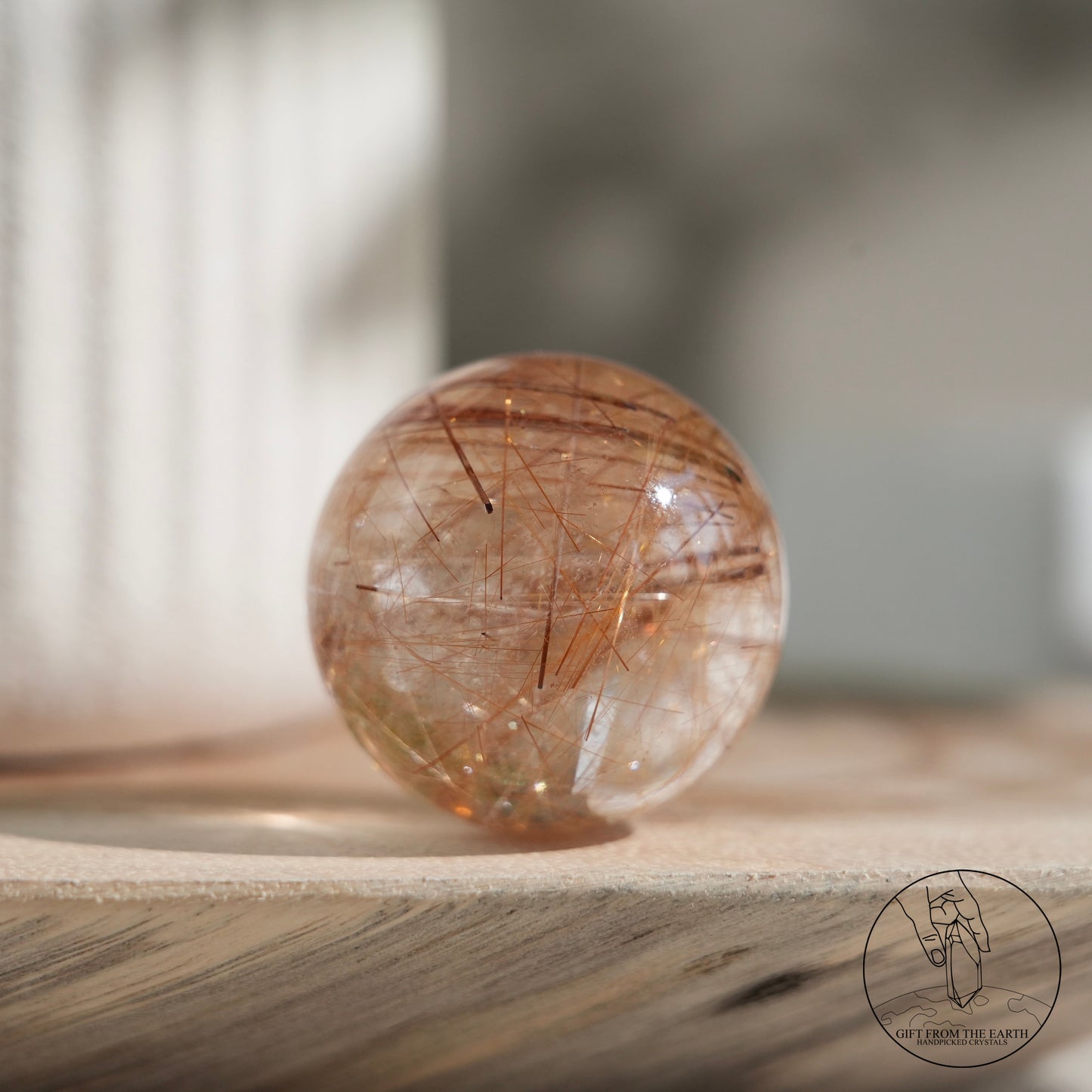 Golden rutilated quartz sphere