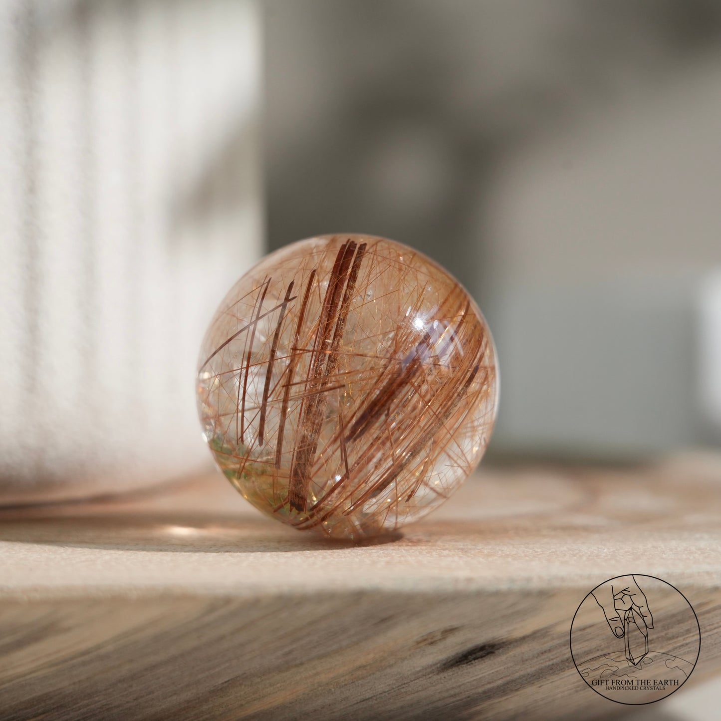 Golden rutilated quartz sphere