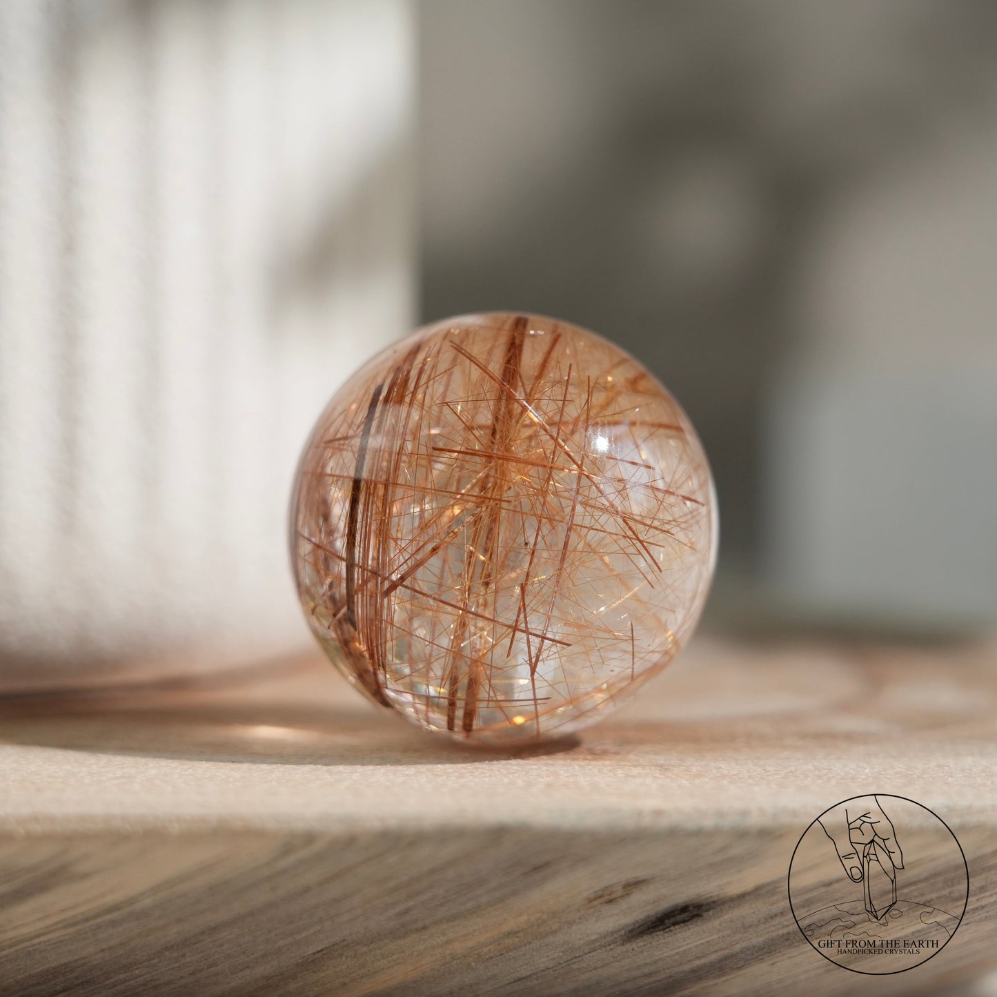 Golden rutilated quartz sphere