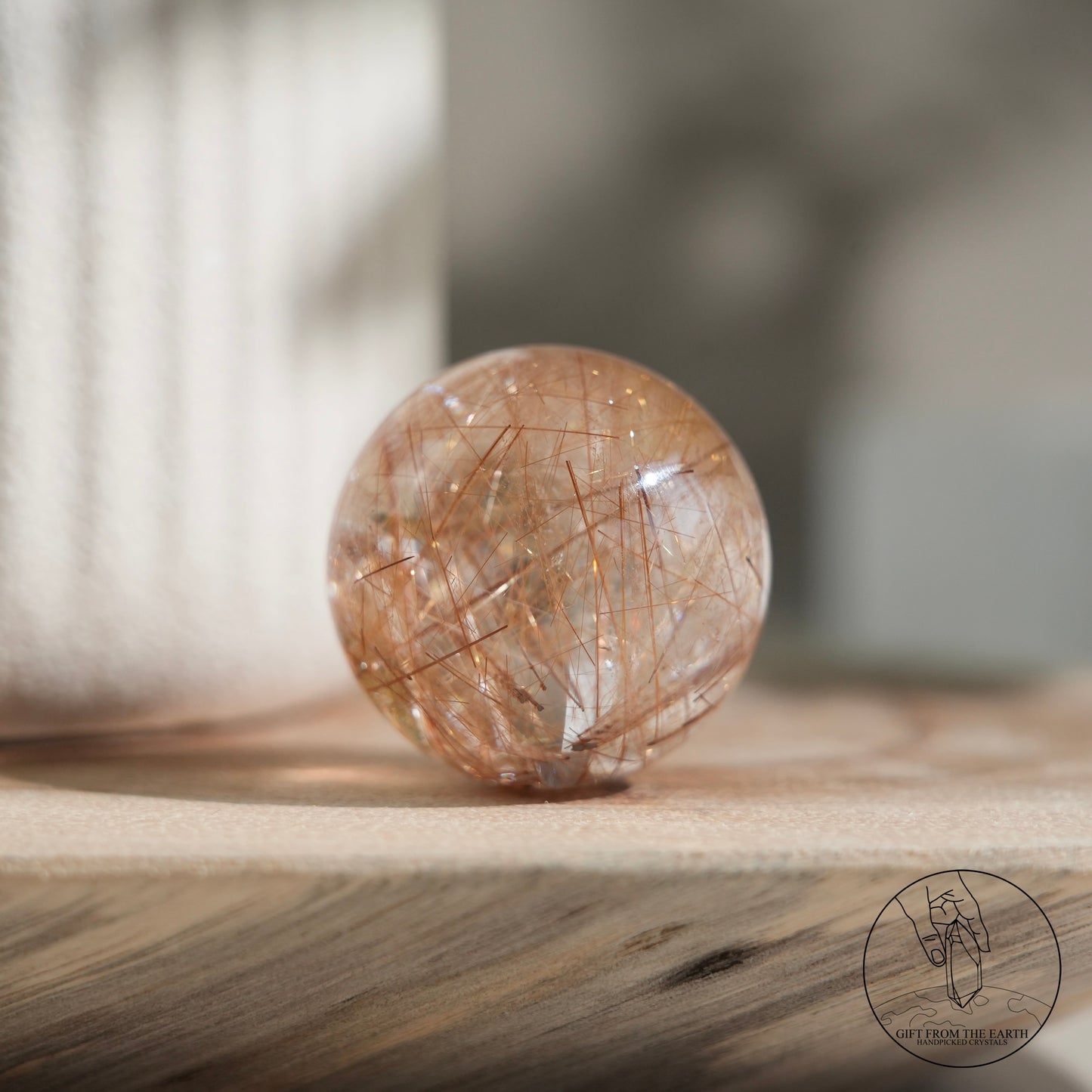 Golden rutilated quartz sphere