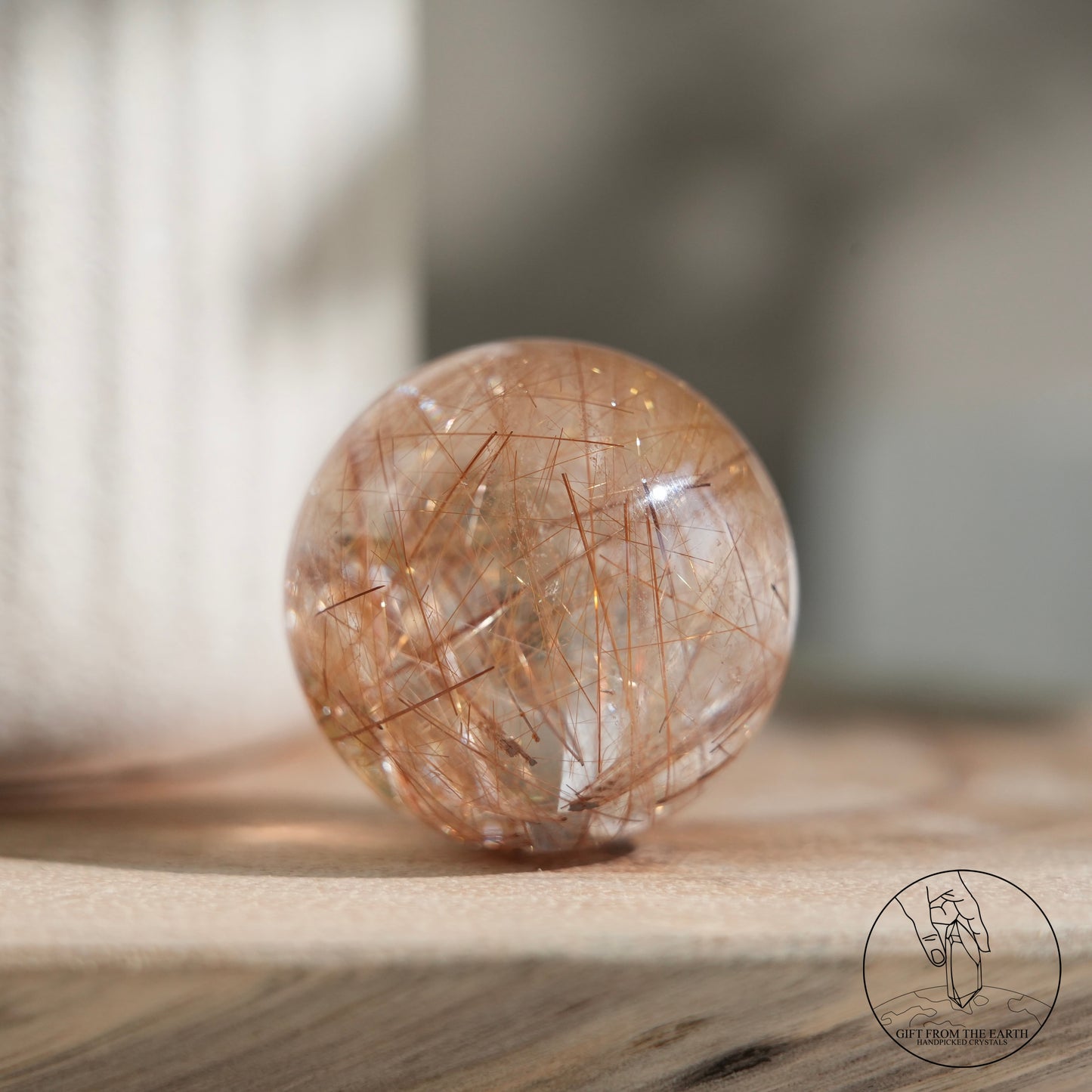 Golden rutilated quartz sphere