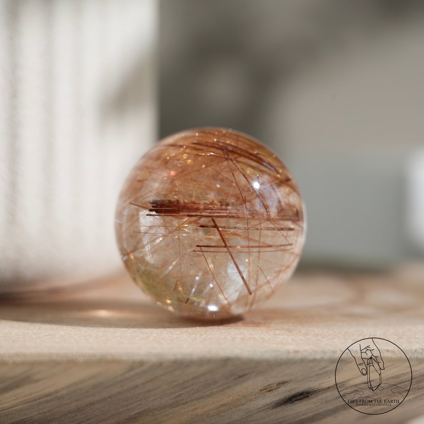 Golden rutilated quartz sphere