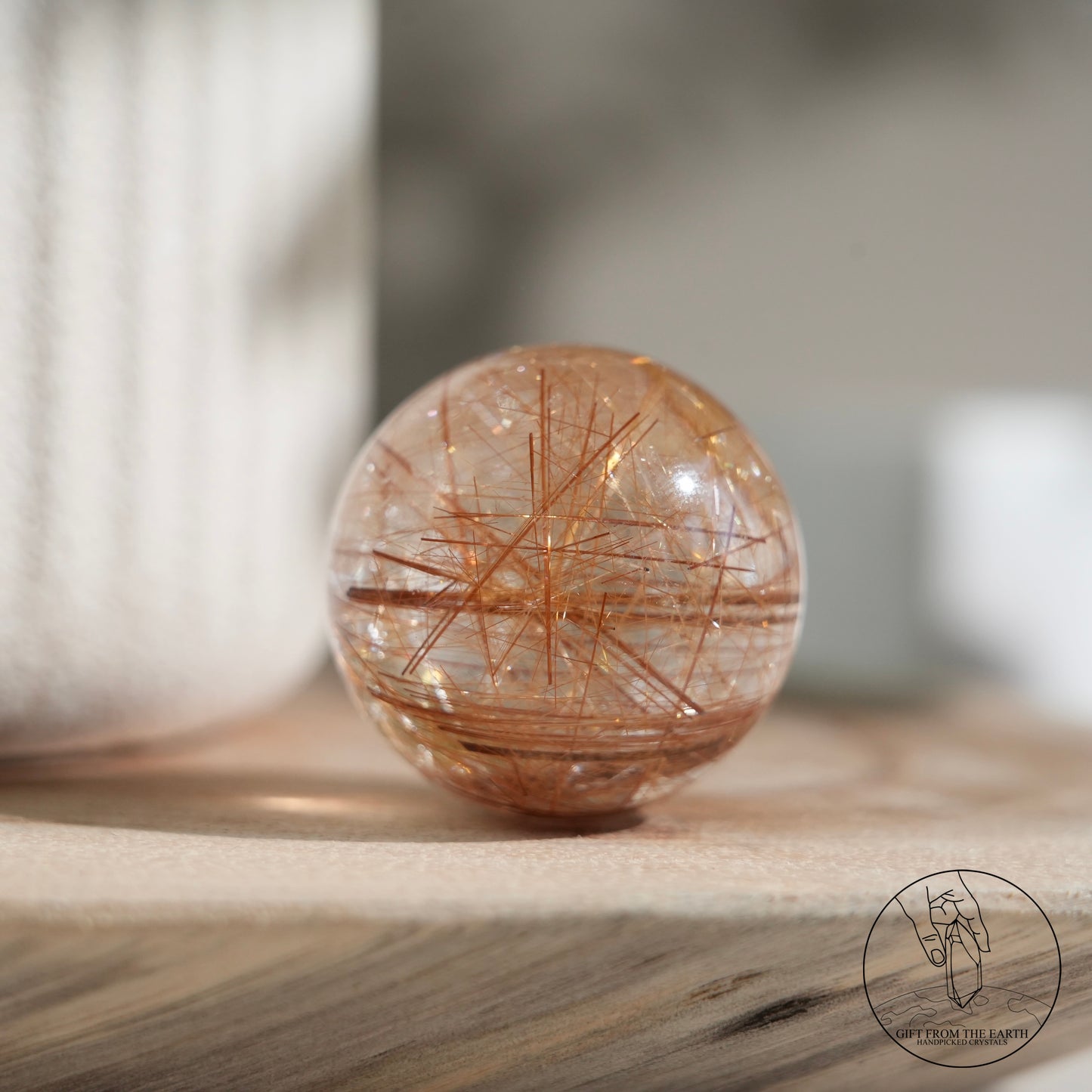 Golden rutilated quartz sphere