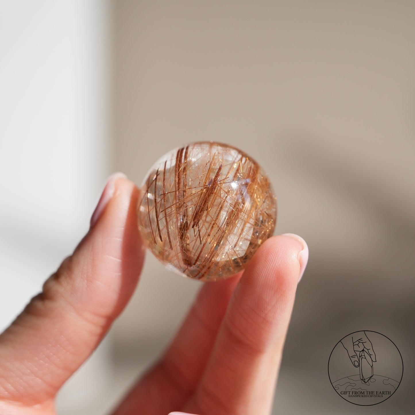 Golden rutilated quartz sphere