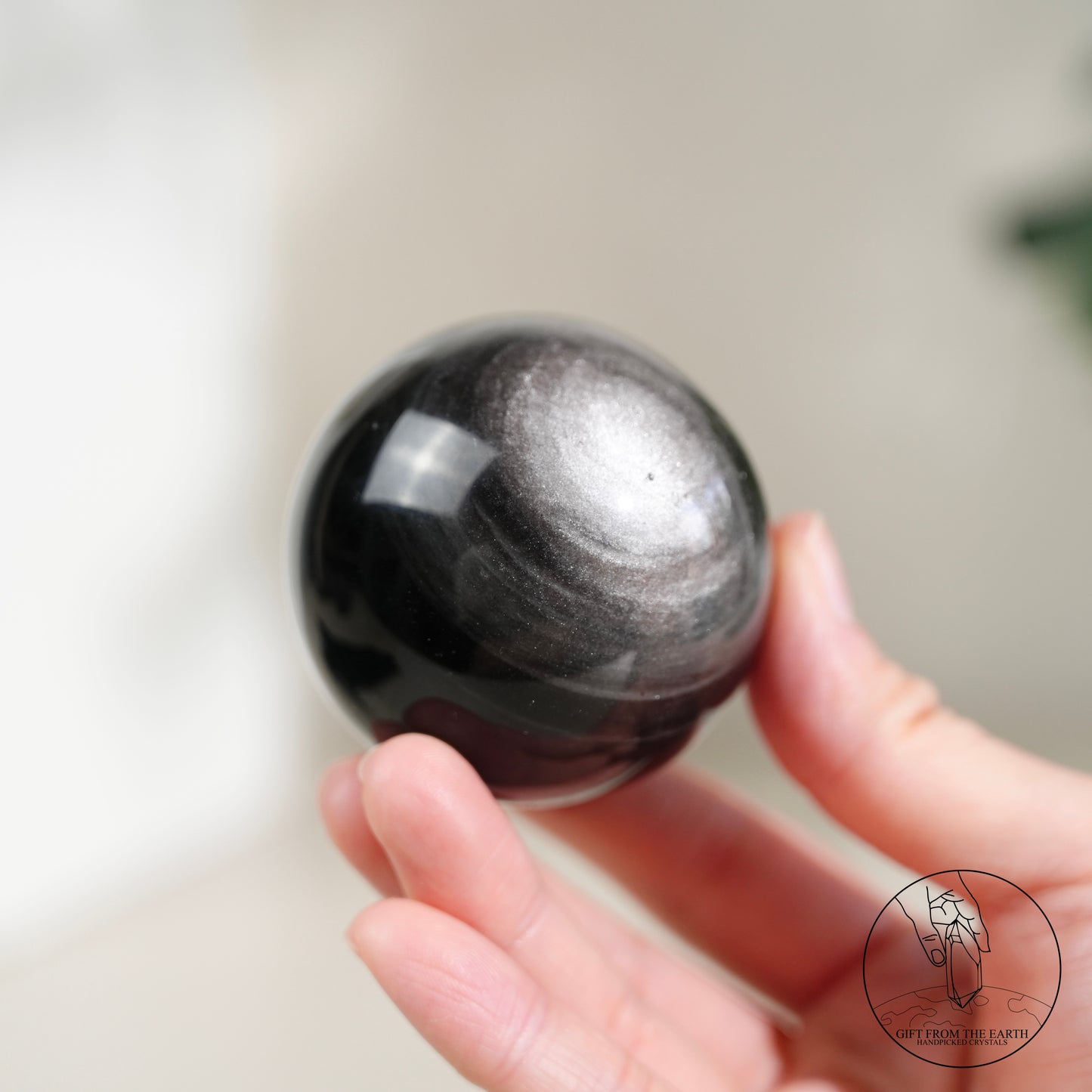 Silver sheen obsidian sphere