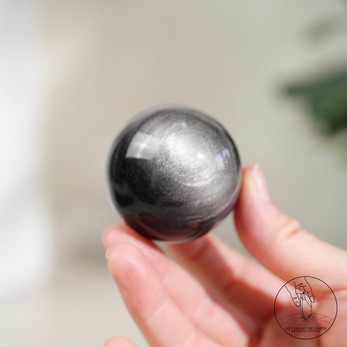 Silver sheen obsidian sphere