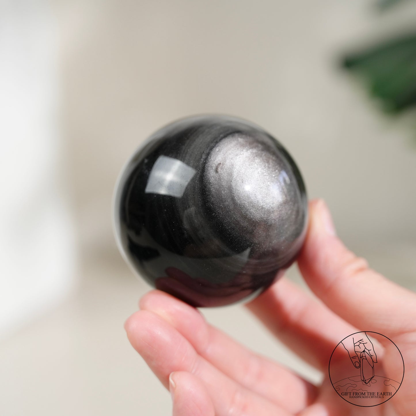 Silver sheen obsidian sphere