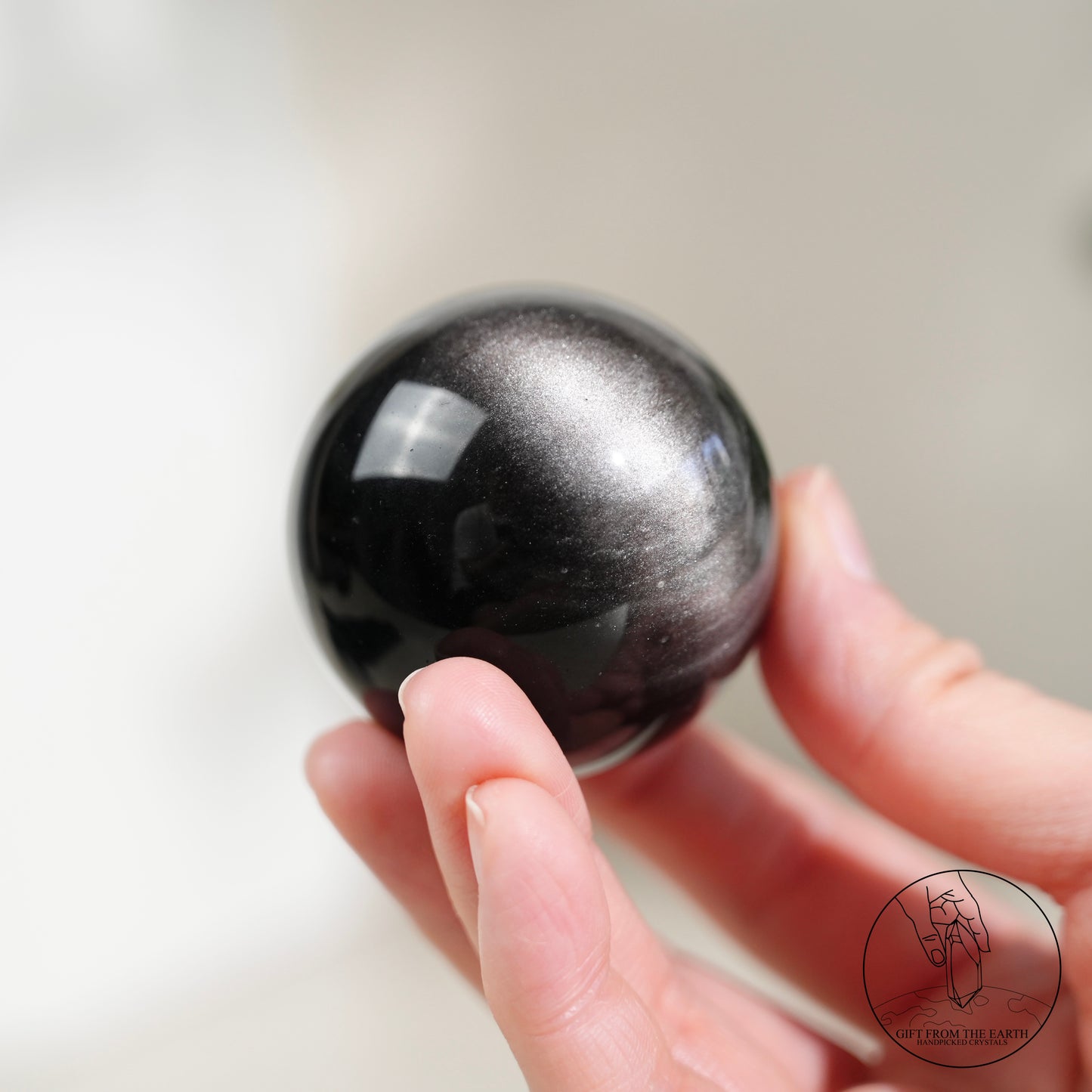 Silver sheen obsidian sphere