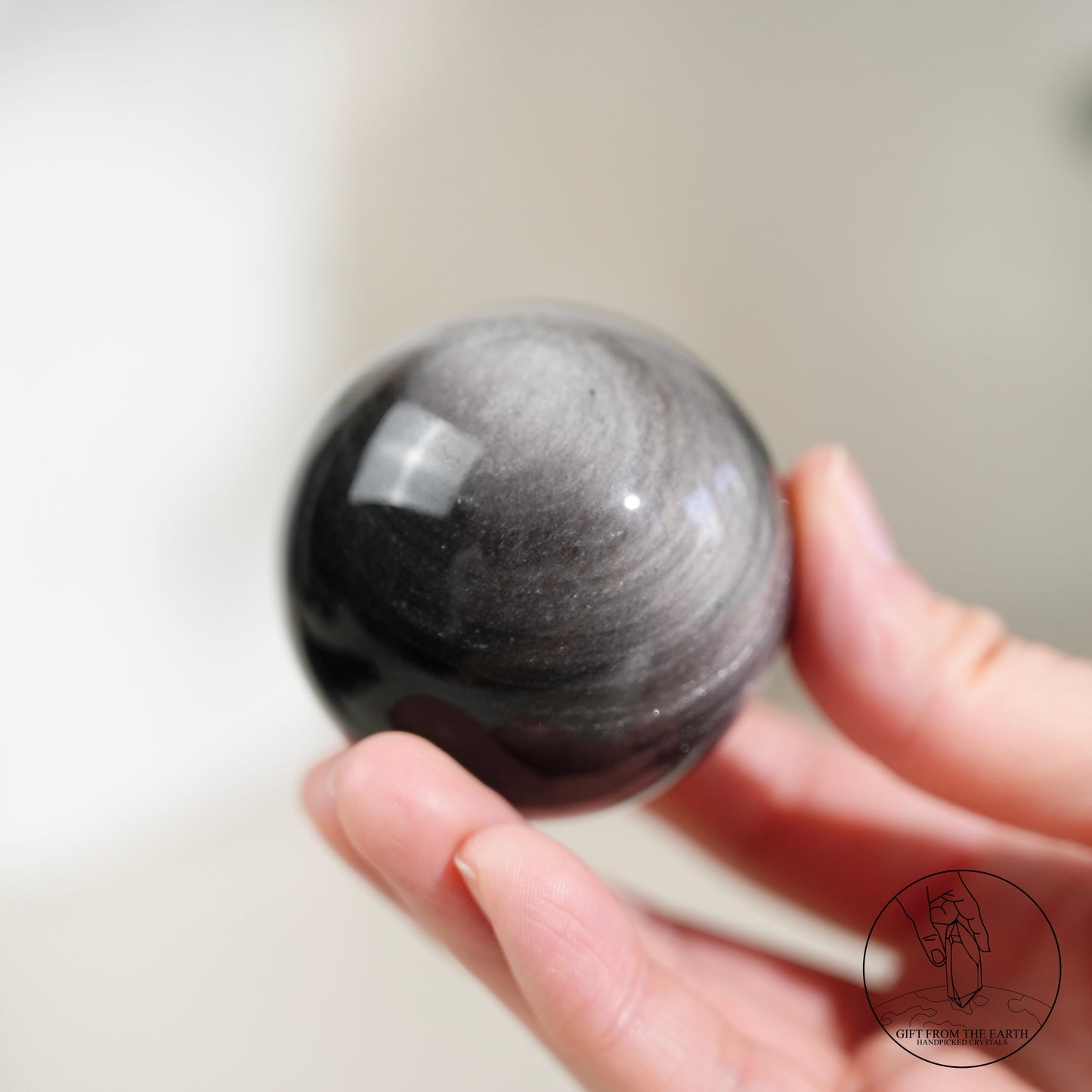 Silver sheen obsidian sphere