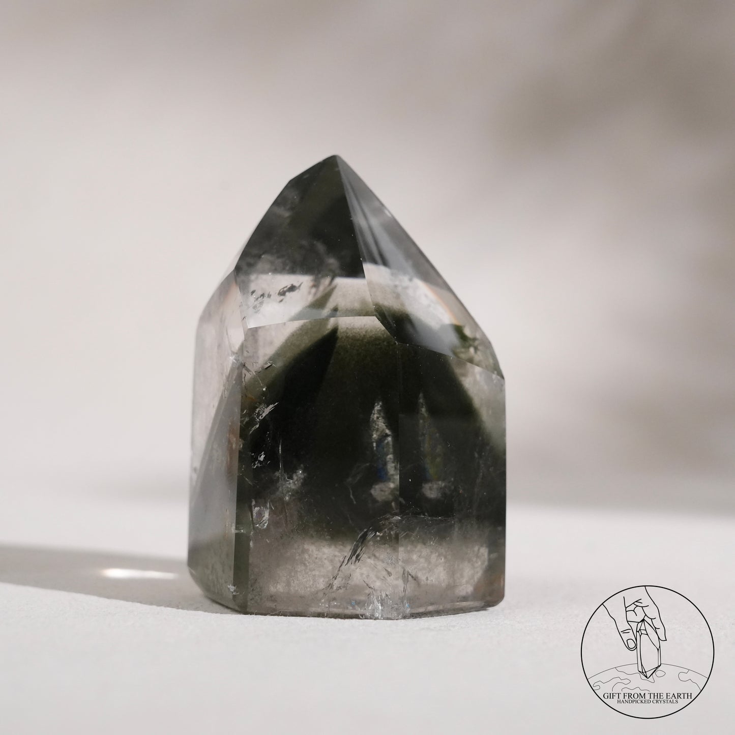 Half-polished multi-layered red-green phantom quartz point