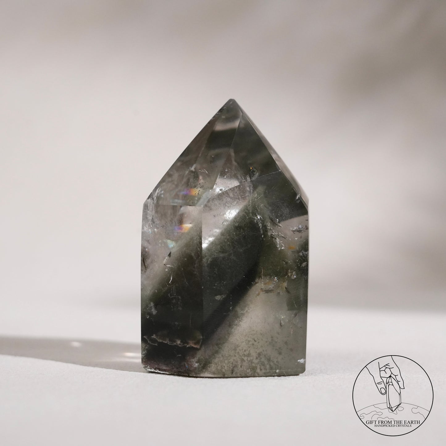 Half-polished multi-layered red-green phantom quartz point