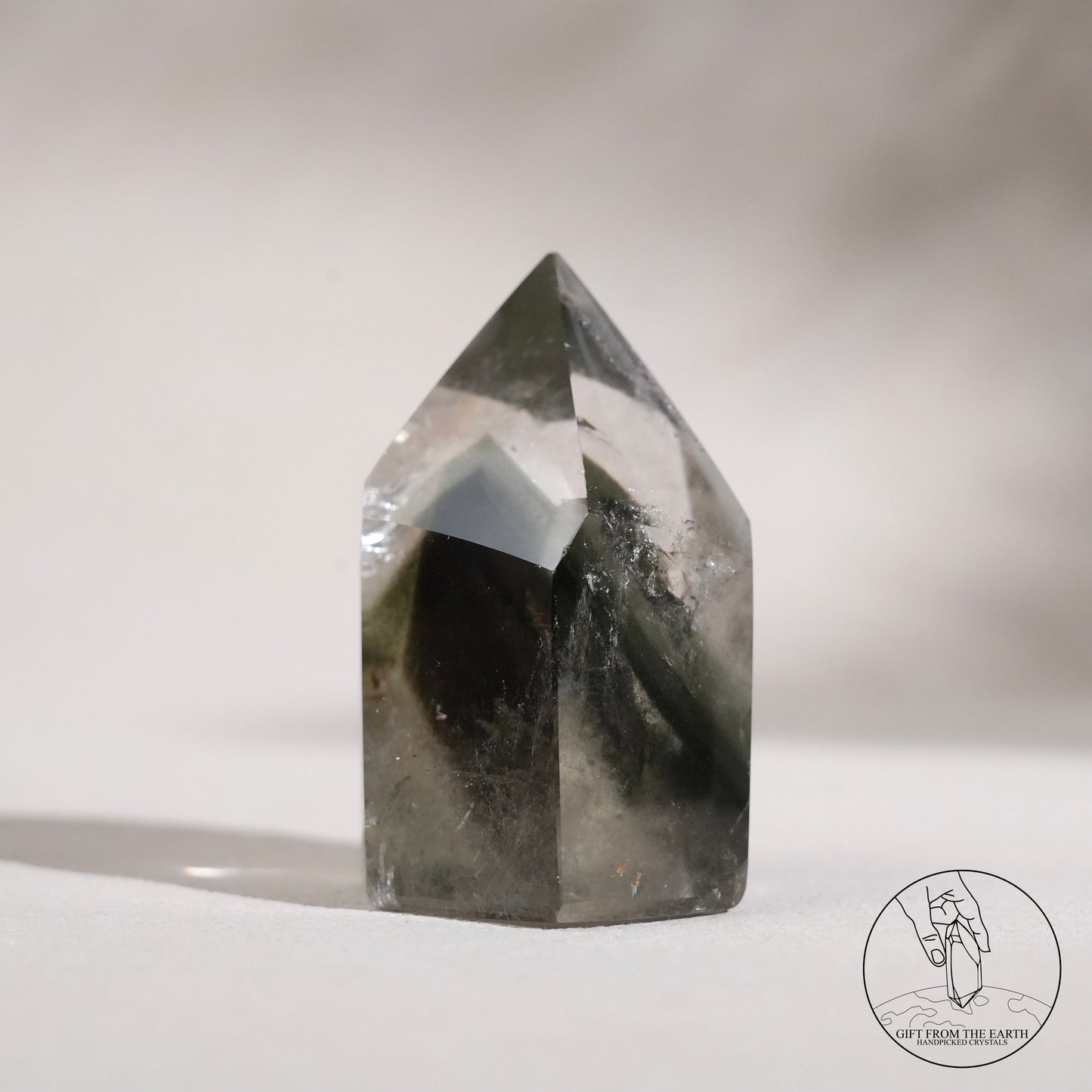 Half-polished multi-layered red-green phantom quartz point