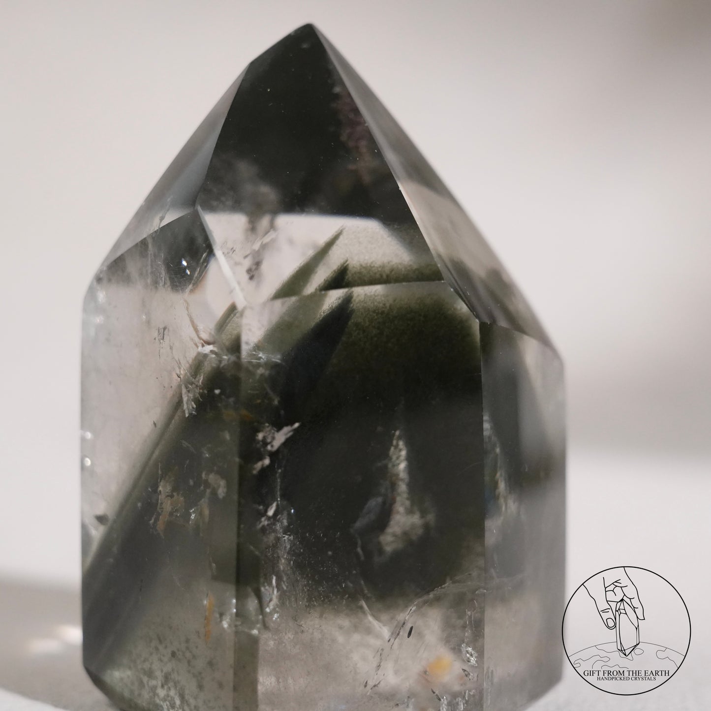 Half-polished multi-layered red-green phantom quartz point