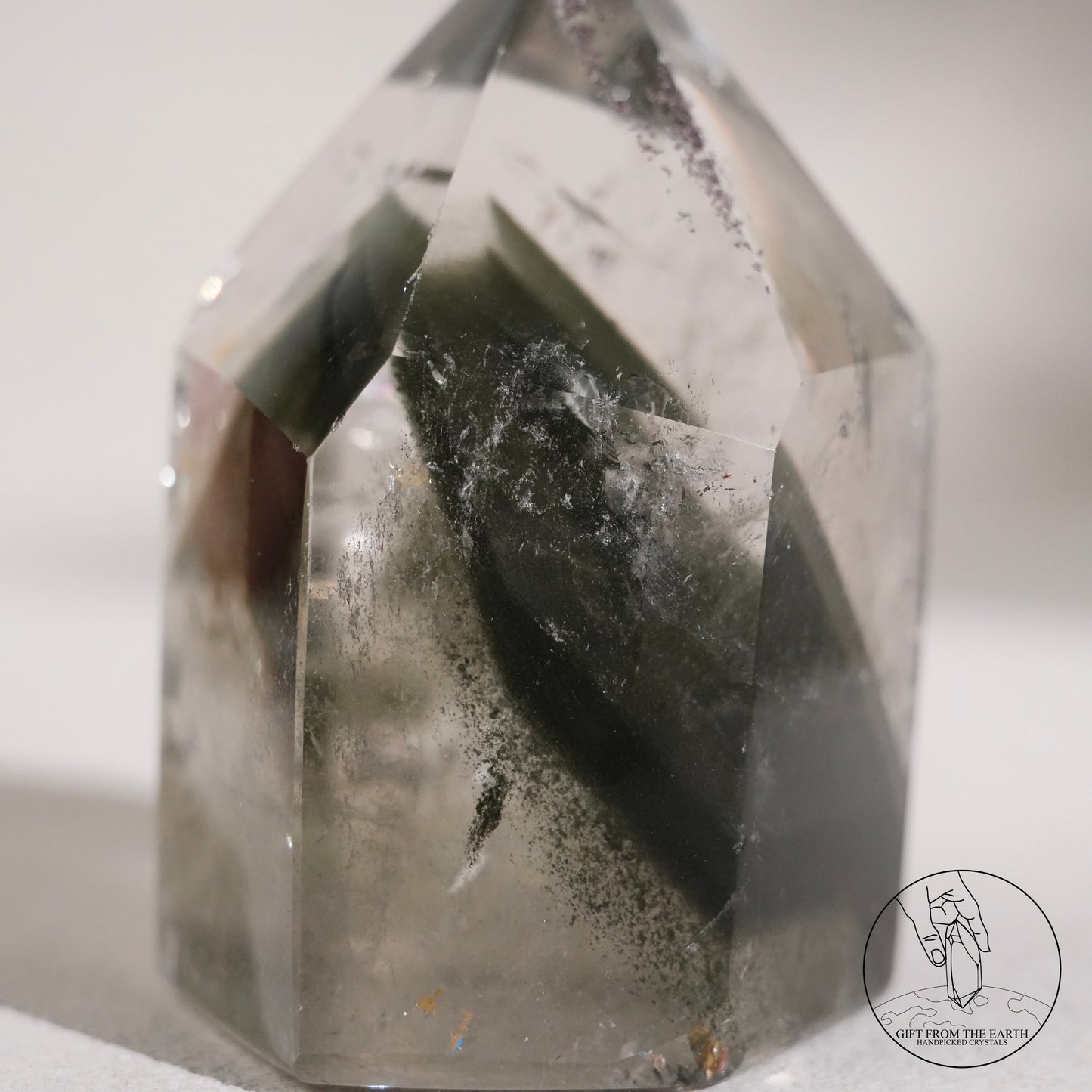 Half-polished multi-layered red-green phantom quartz point