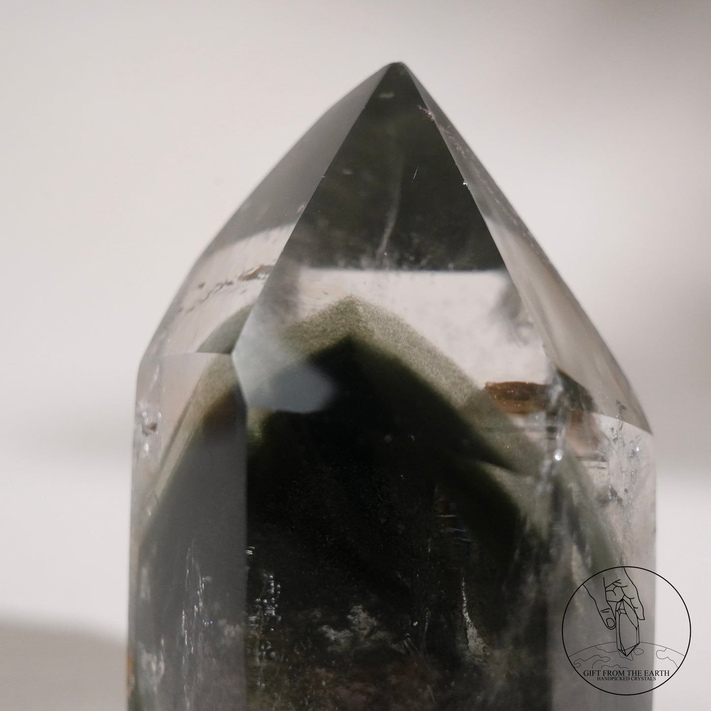 Half-polished multi-layered red-green phantom quartz point