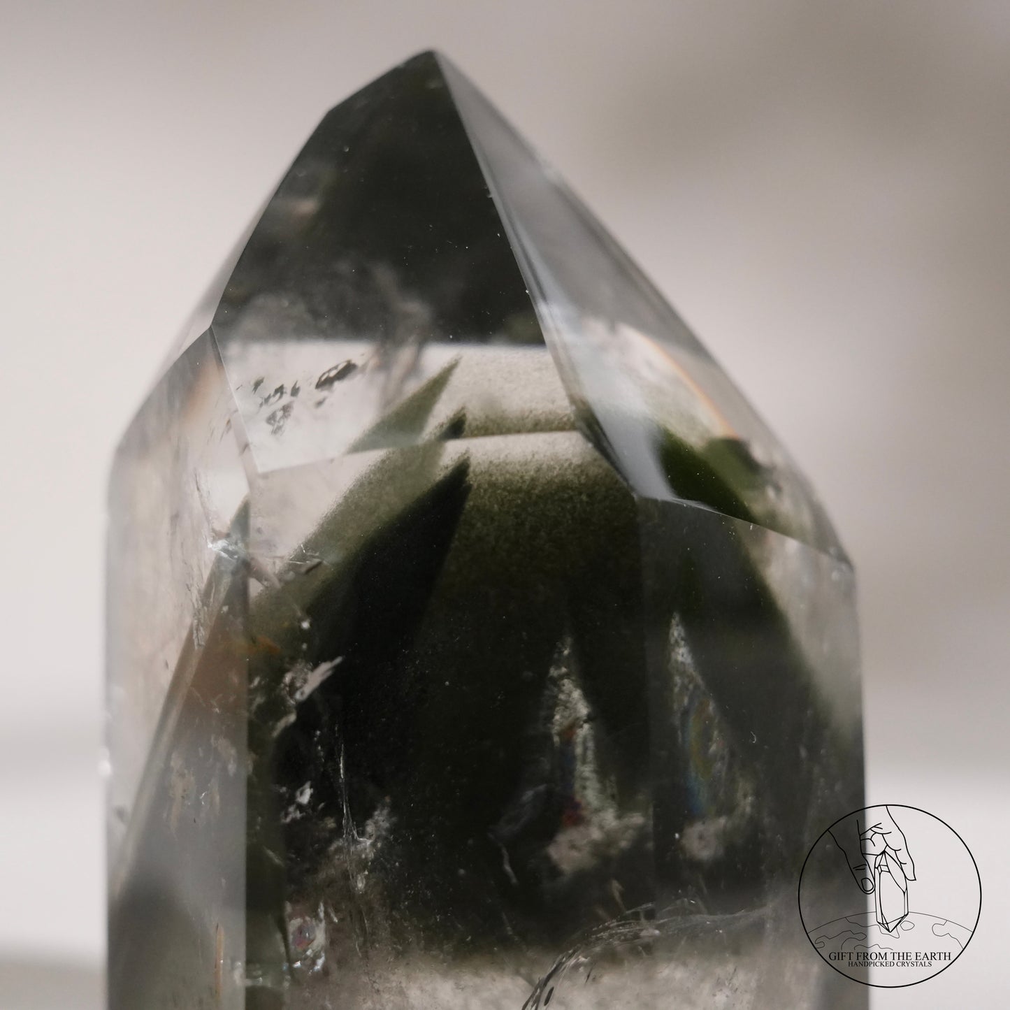 Half-polished multi-layered red-green phantom quartz point