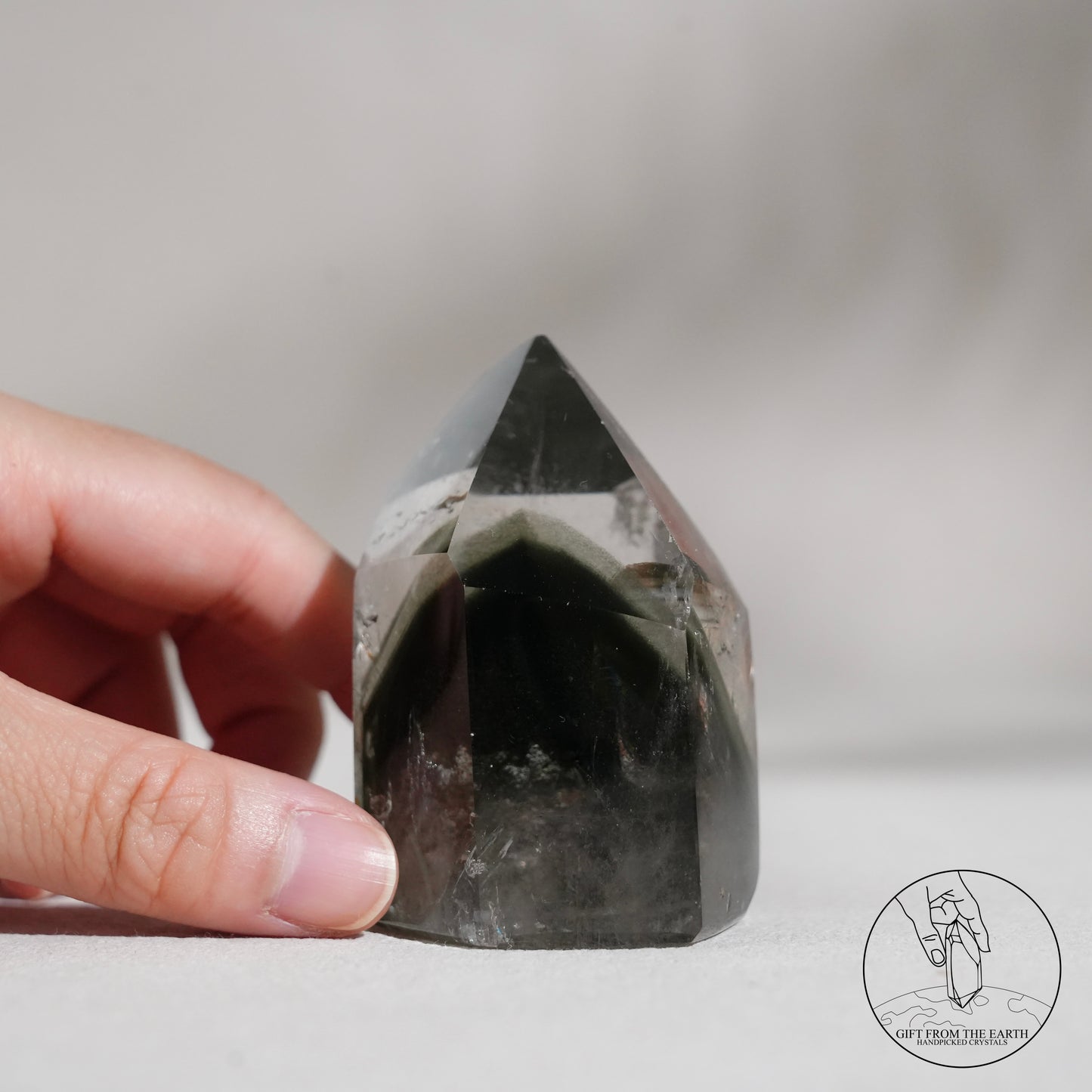 Half-polished multi-layered red-green phantom quartz point