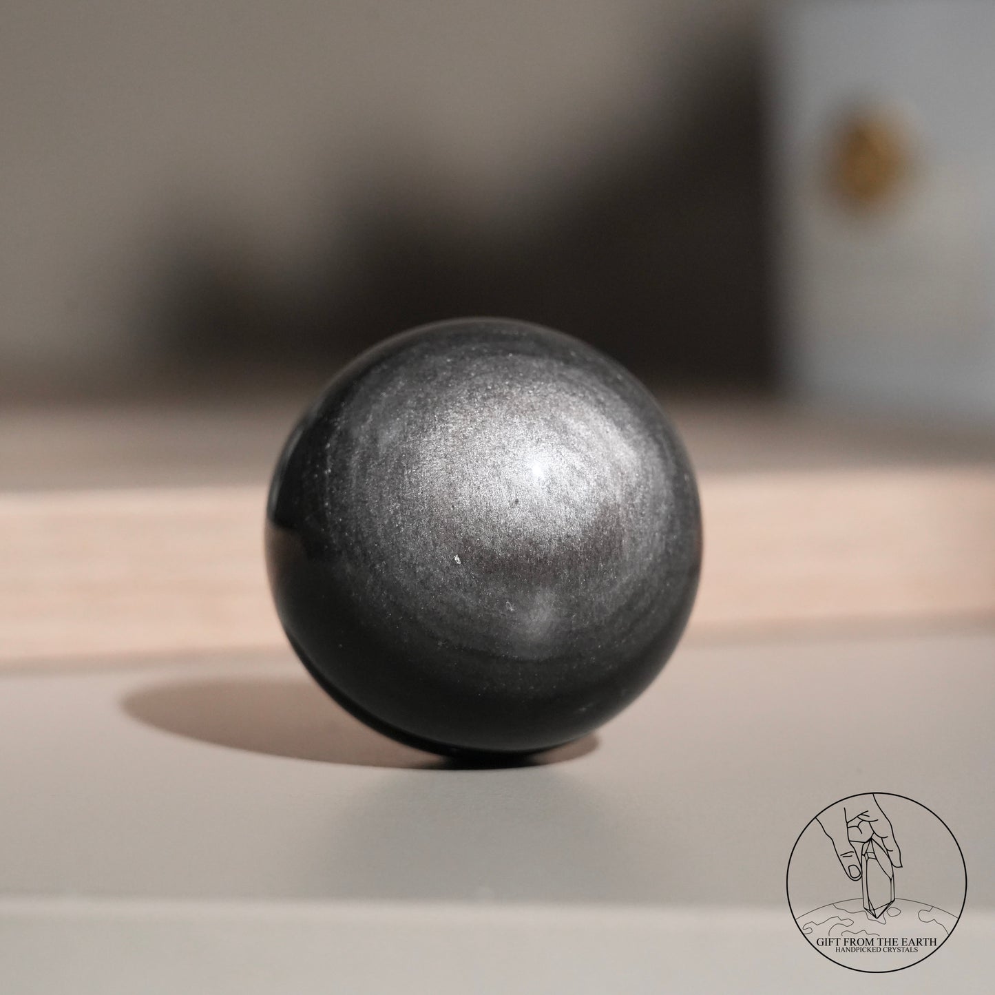 Silver sheen obsidian sphere