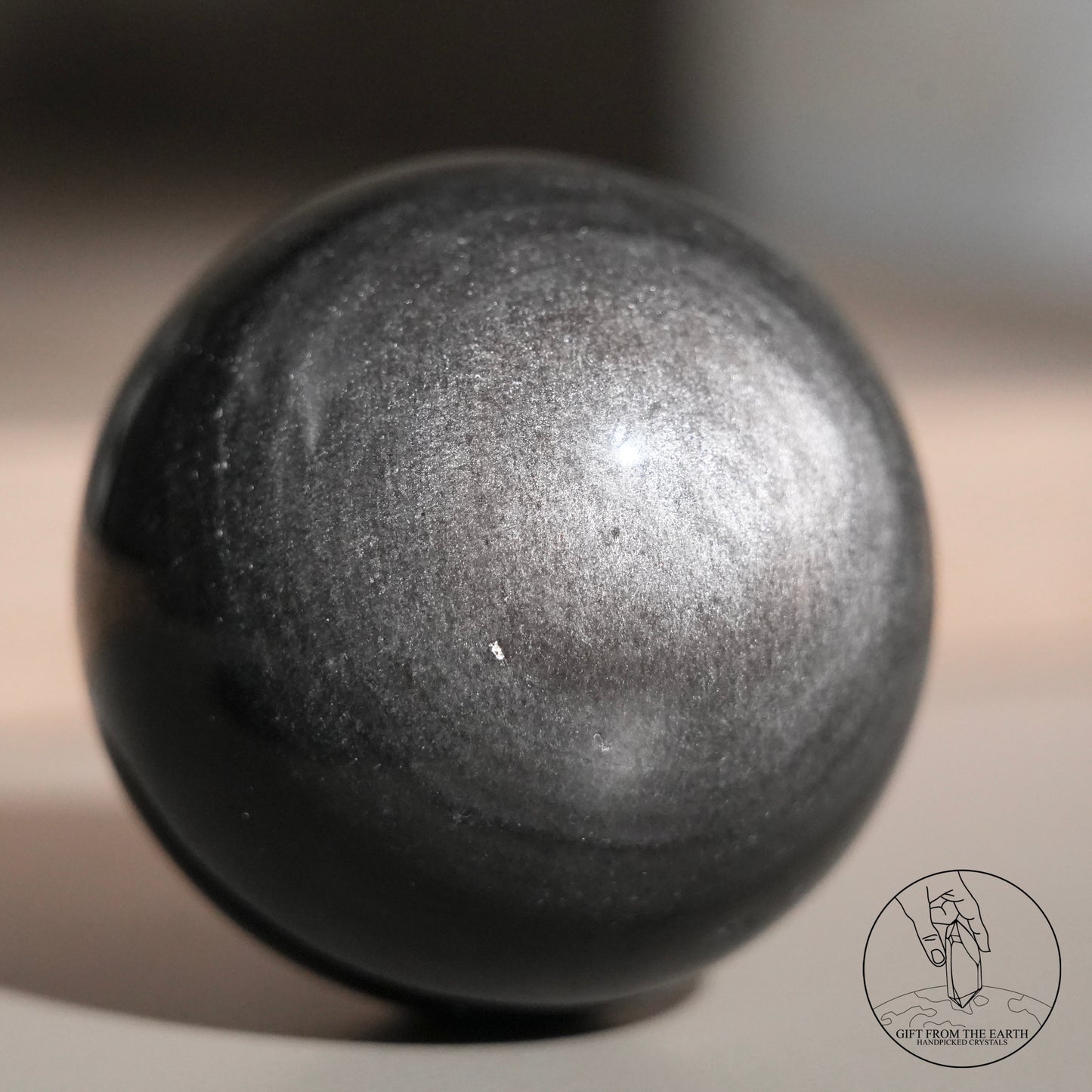Silver sheen obsidian sphere