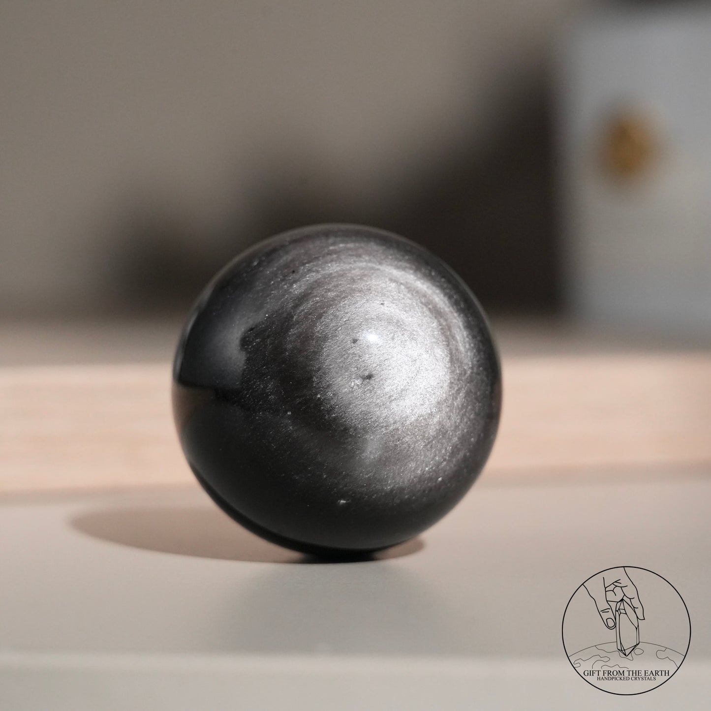 Silver sheen obsidian sphere