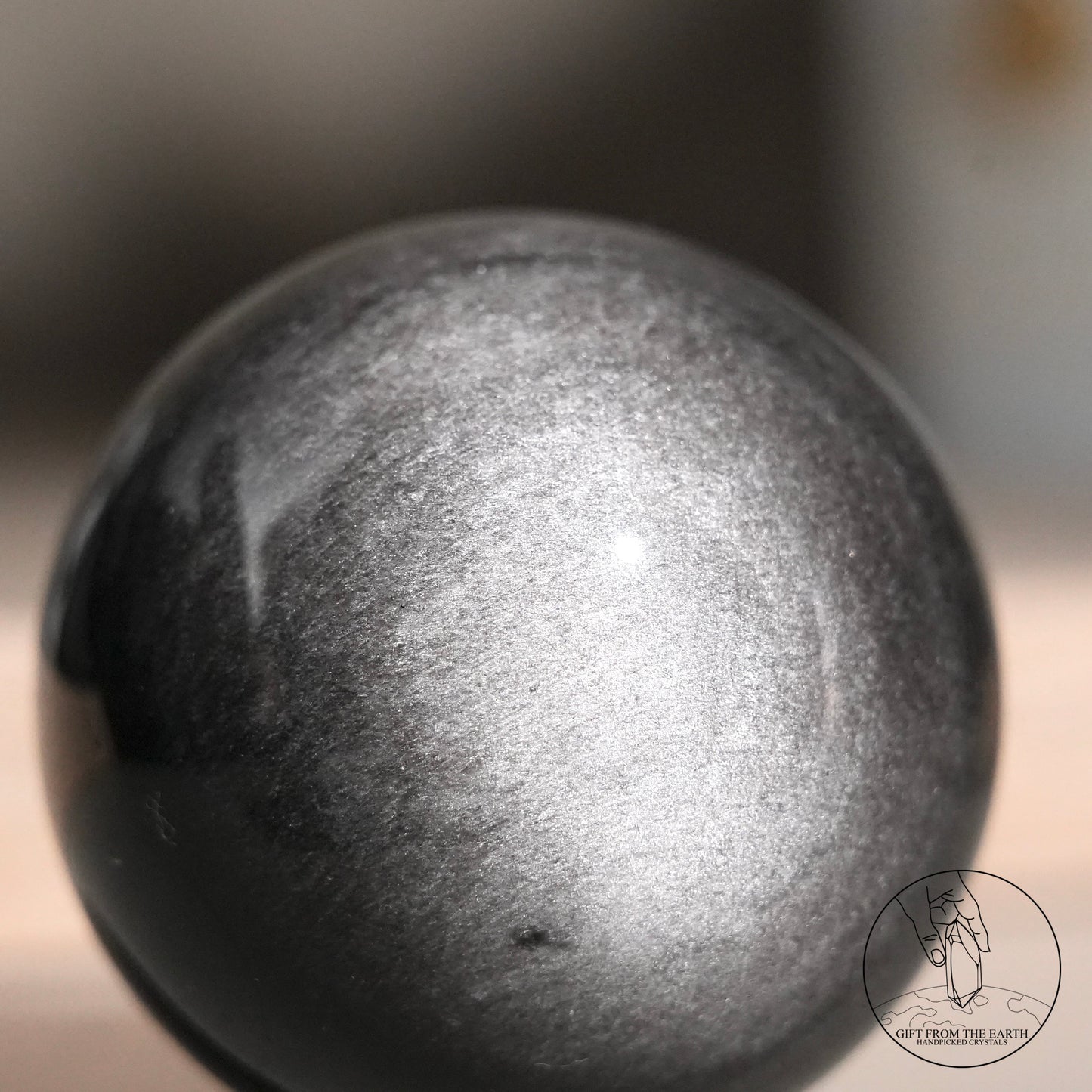 Silver sheen obsidian sphere