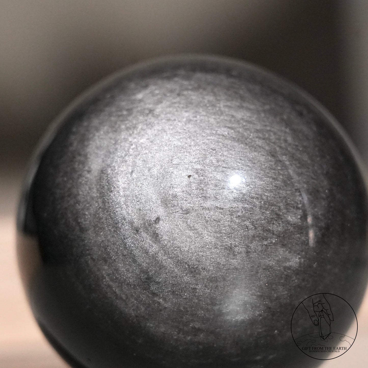 Silver sheen obsidian sphere