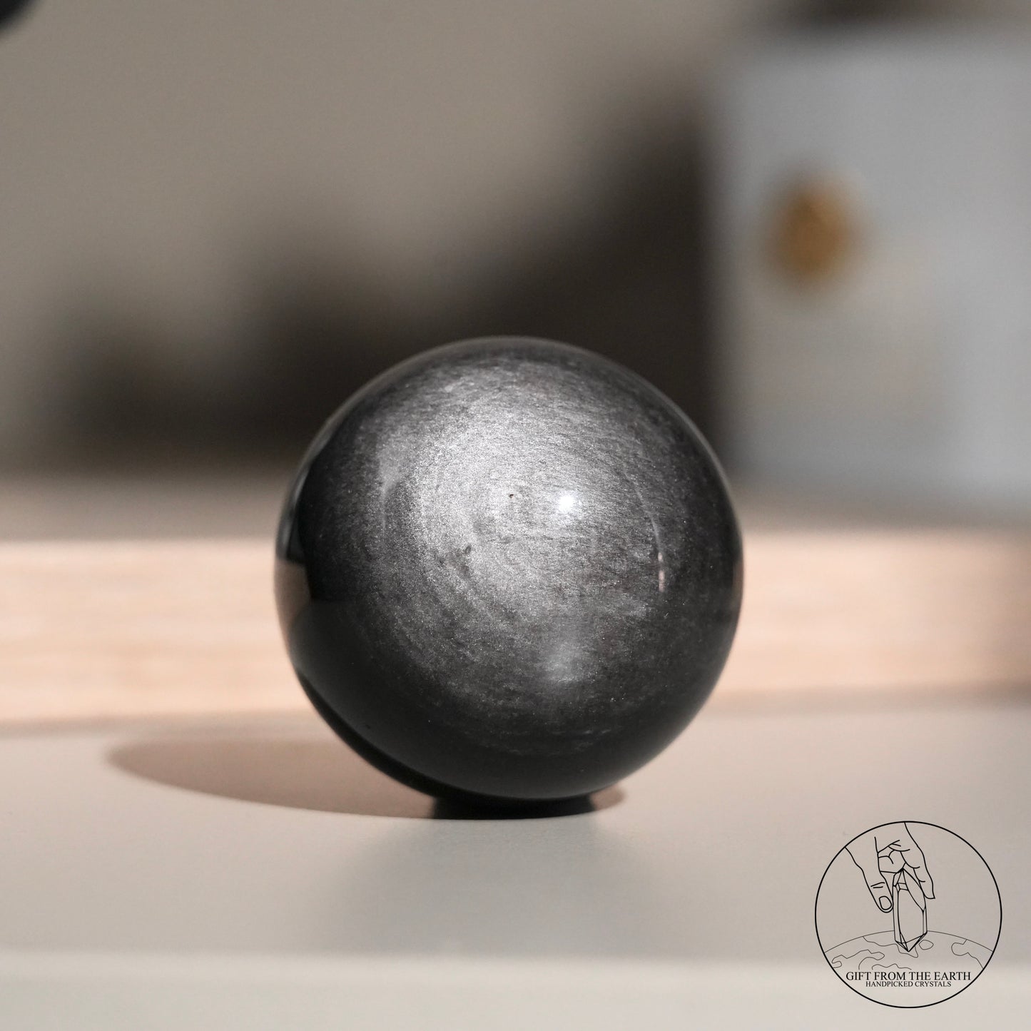 Silver sheen obsidian sphere