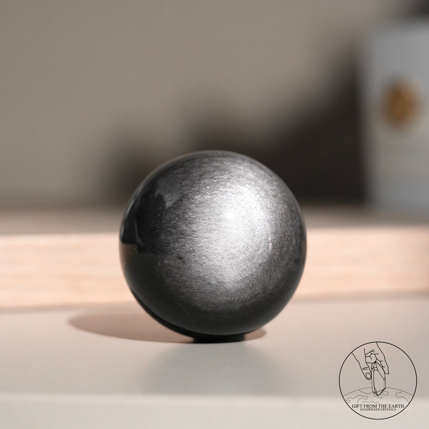 Silver sheen obsidian sphere