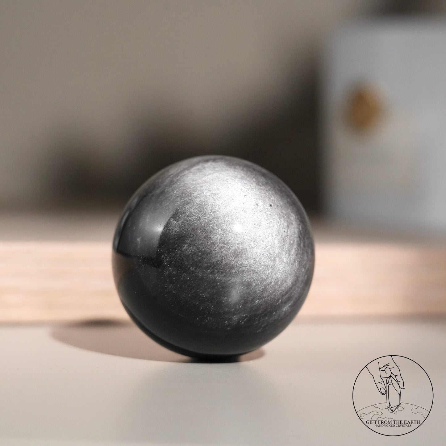 Silver sheen obsidian sphere