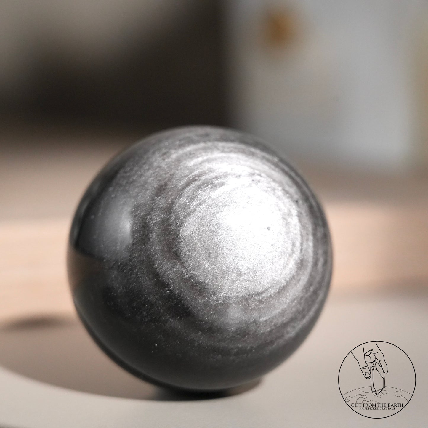 Silver sheen obsidian sphere