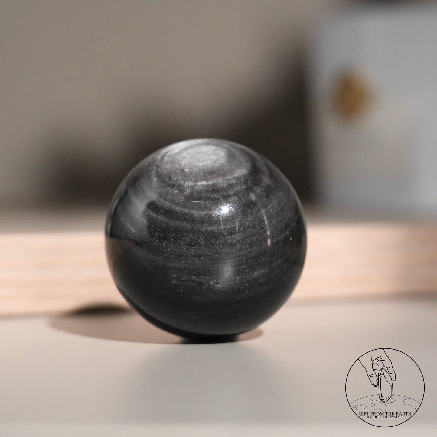 Silver sheen obsidian sphere