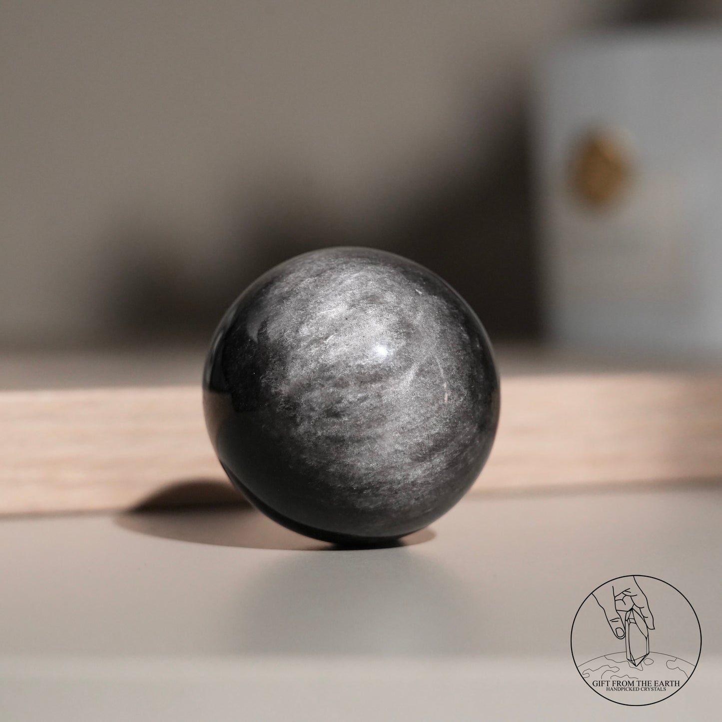 Silver sheen obsidian sphere