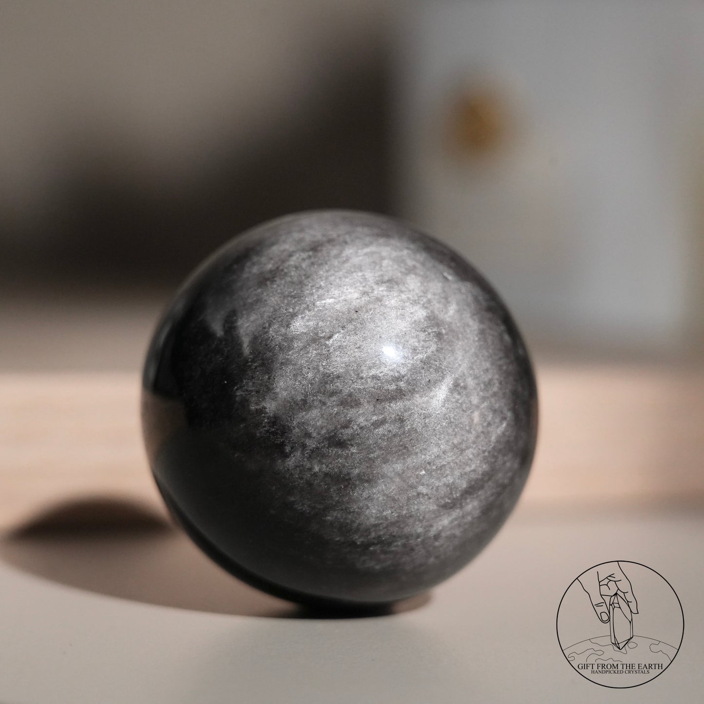 Silver sheen obsidian sphere