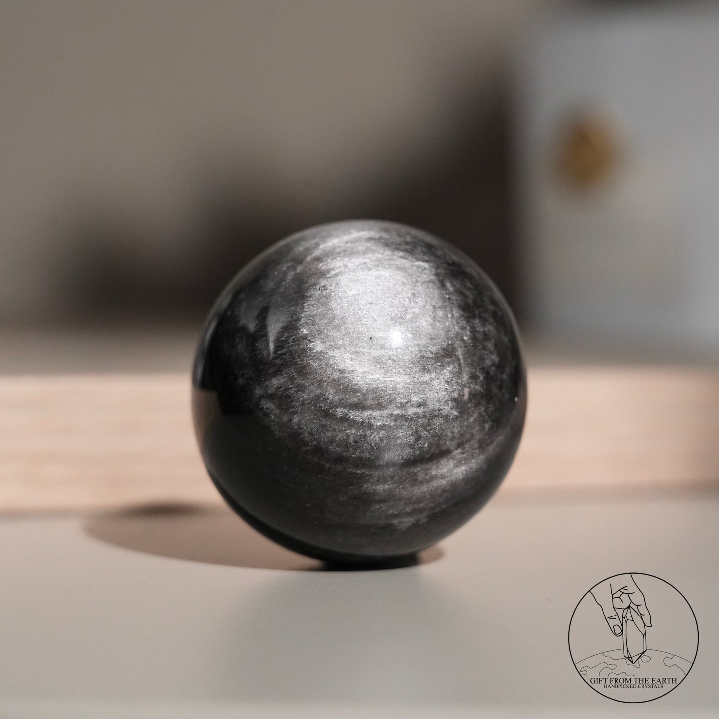 Silver sheen obsidian sphere