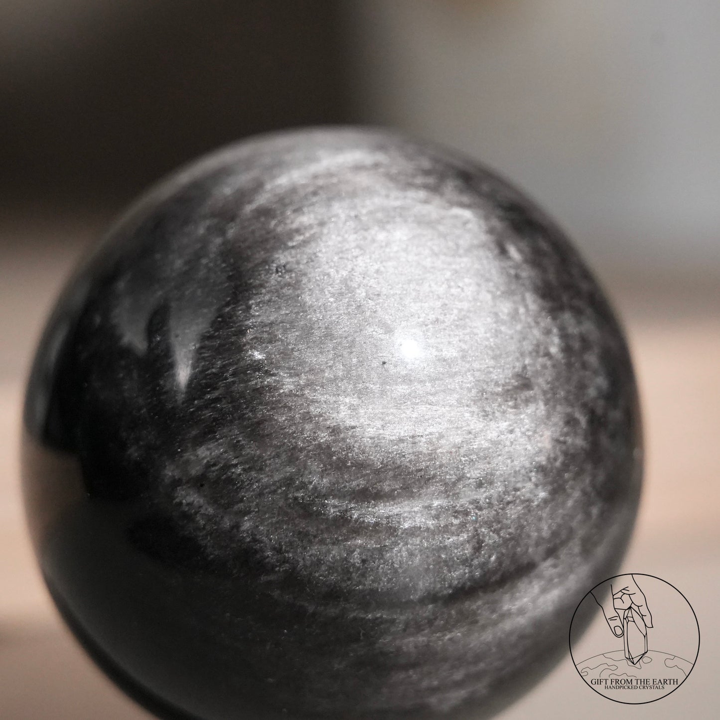 Silver sheen obsidian sphere