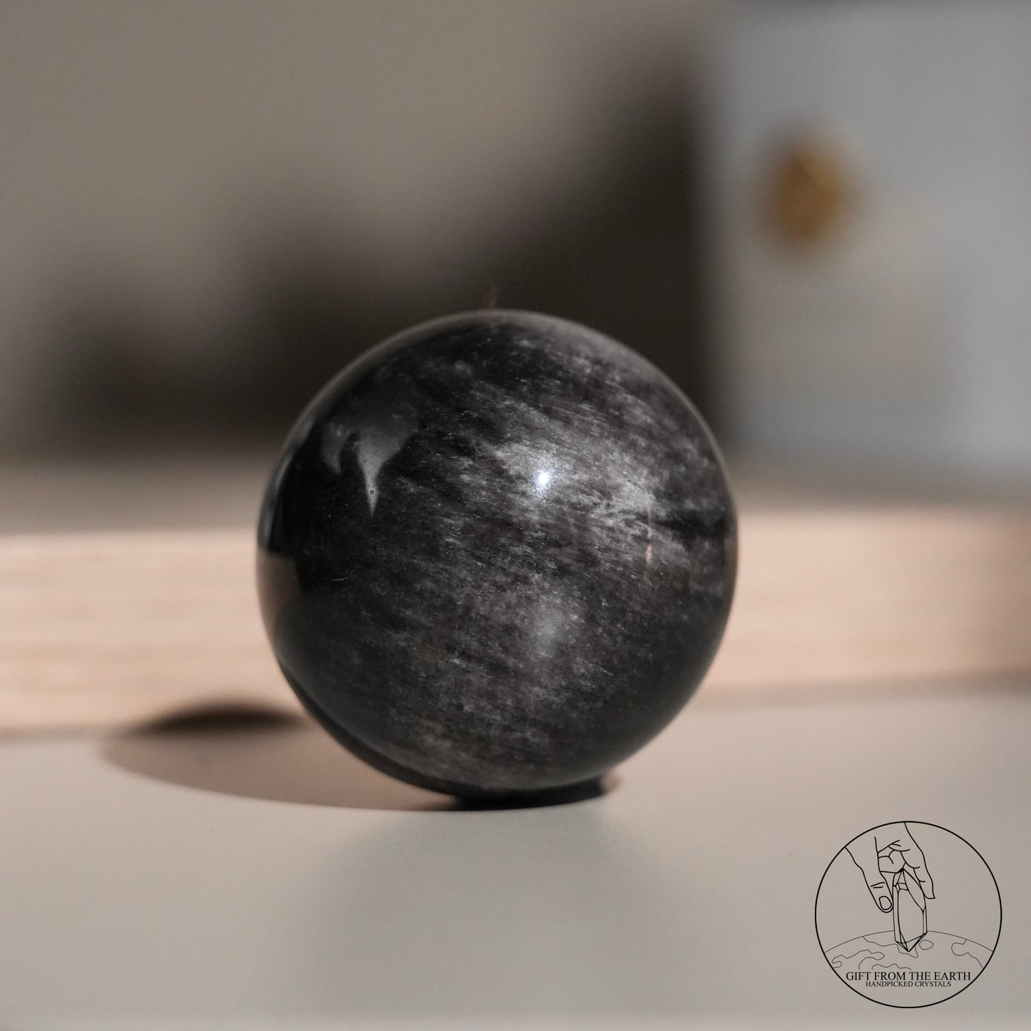 Silver sheen obsidian sphere