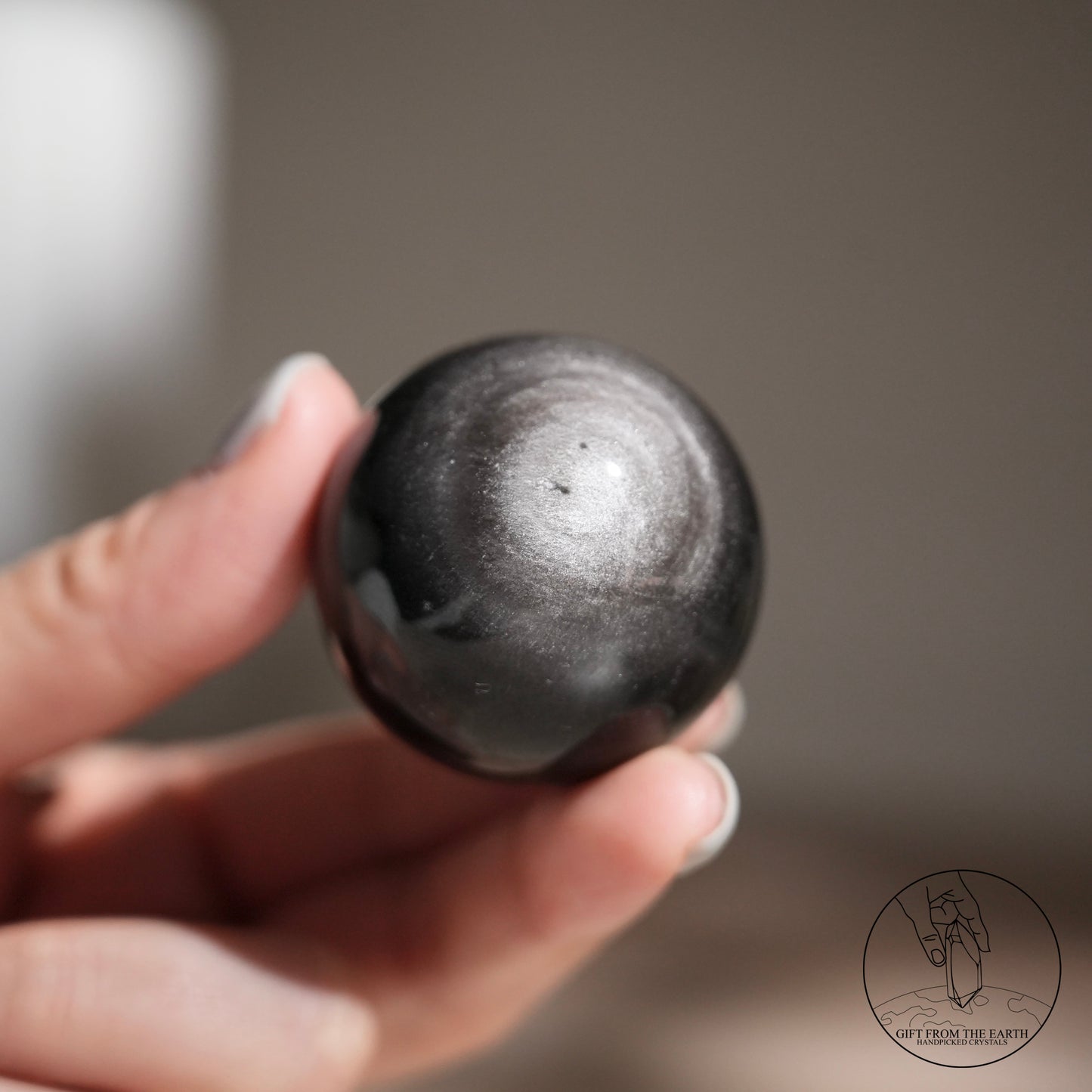 Silver sheen obsidian sphere