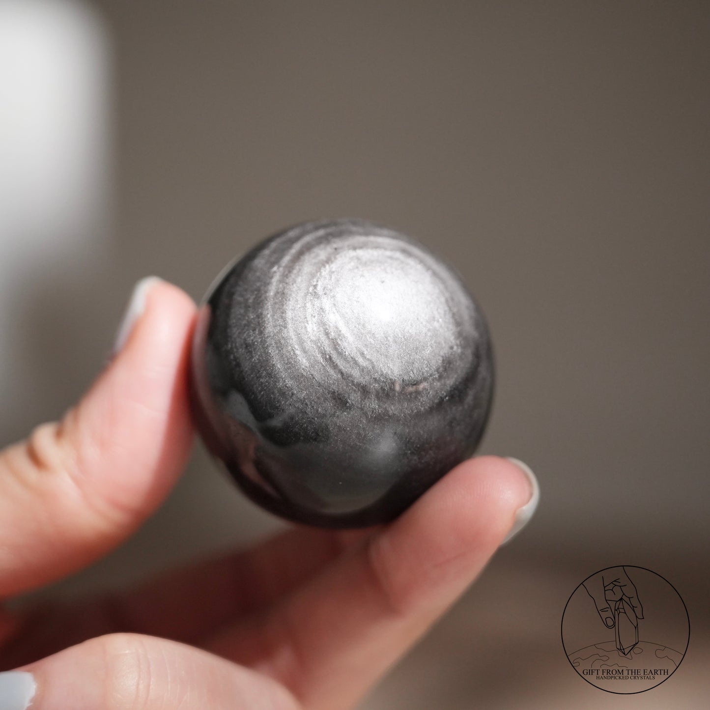 Silver sheen obsidian sphere
