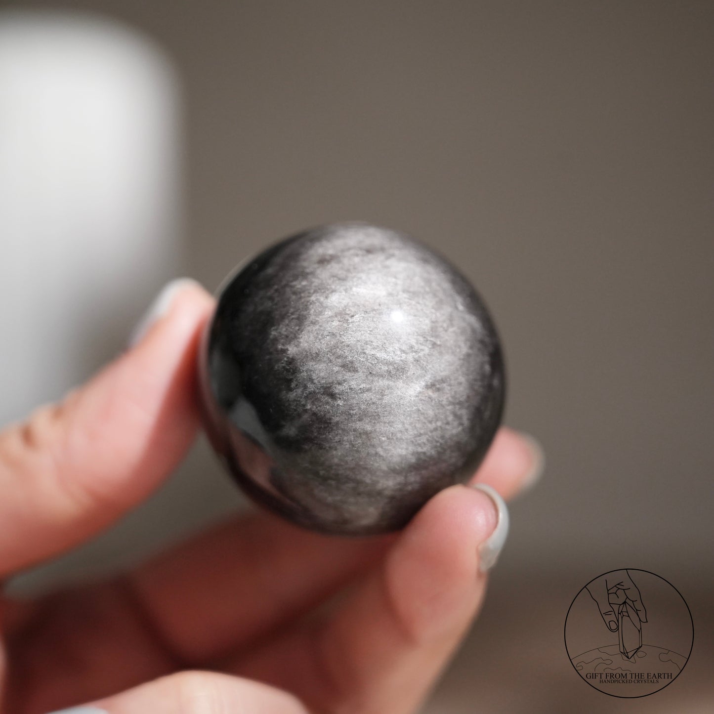 Silver sheen obsidian sphere
